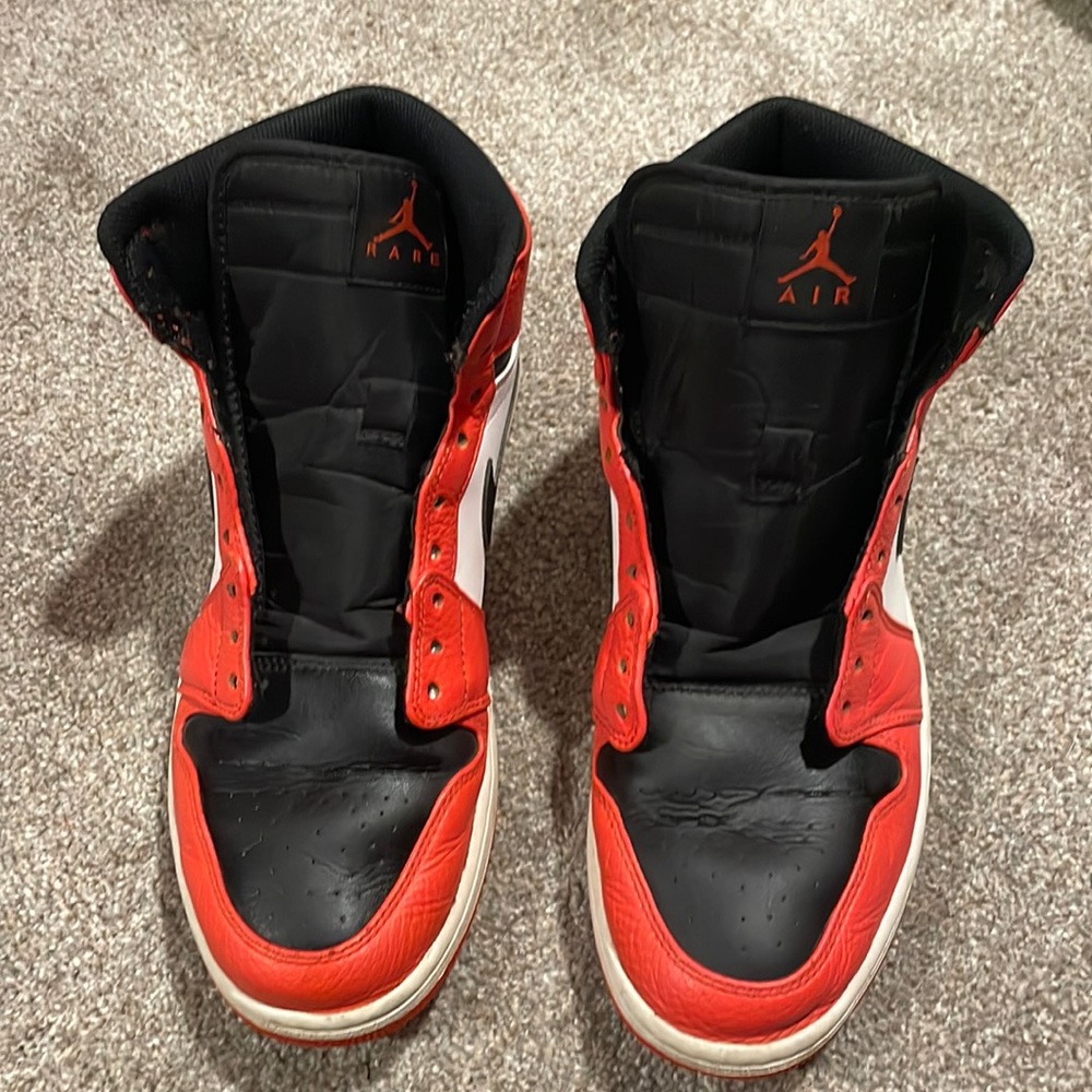 Nike air Jordan’s size 11 red-orange, black, and white.